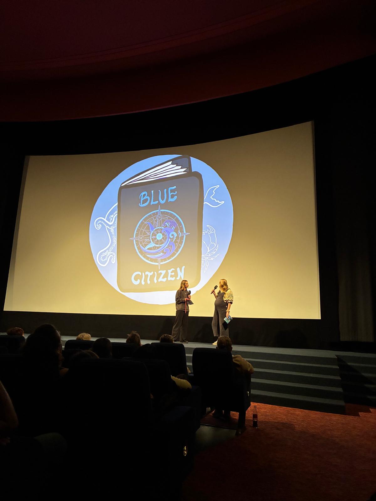 Blue Citizen being presented on stage at a cinema
