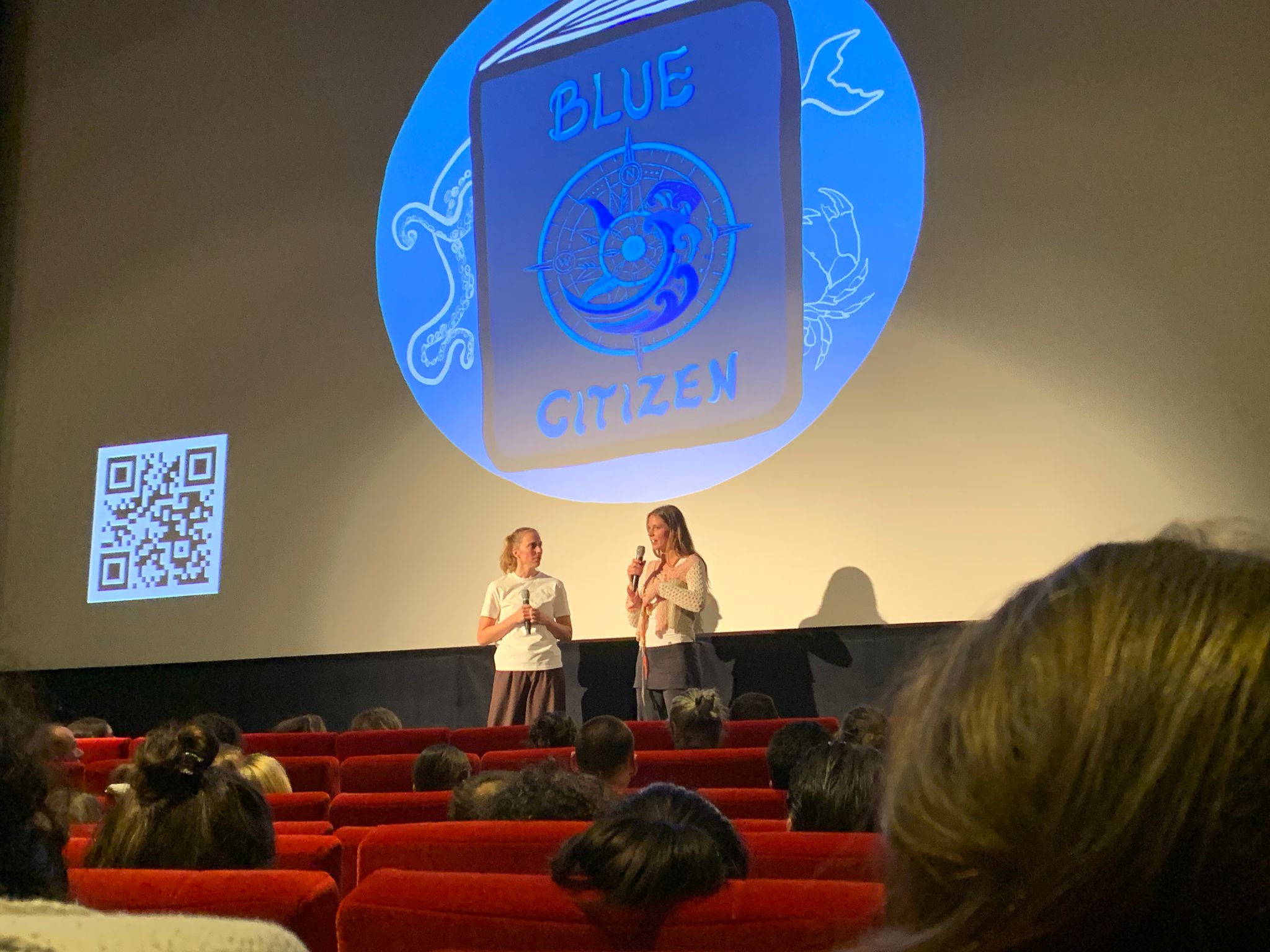 A Blue Citizen speaker addressing an audience at a cinema